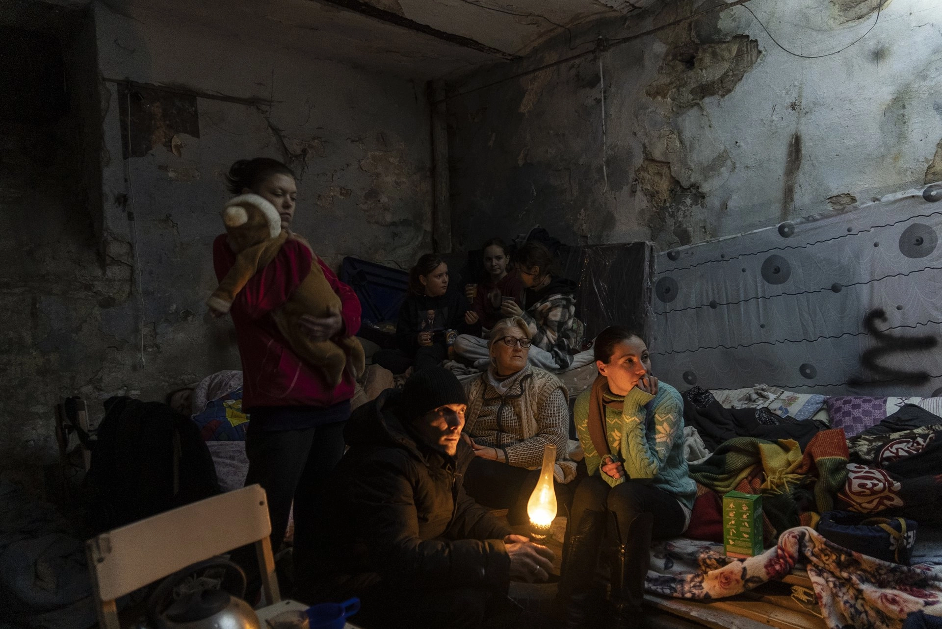 Zhanna Goma (right) and her neighbors settle in a bomb shelter in Mariupol, Ukraine.