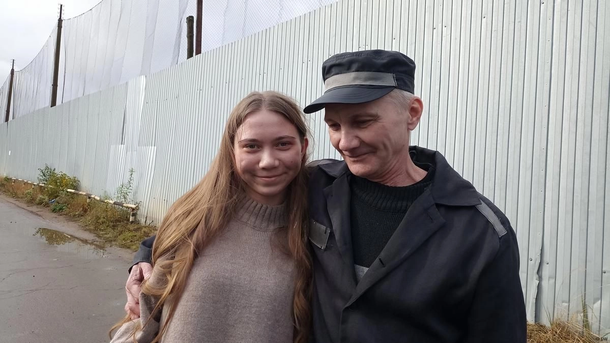 Alexei Moskalev hugs his daughter Masha after being released from a Russian prison